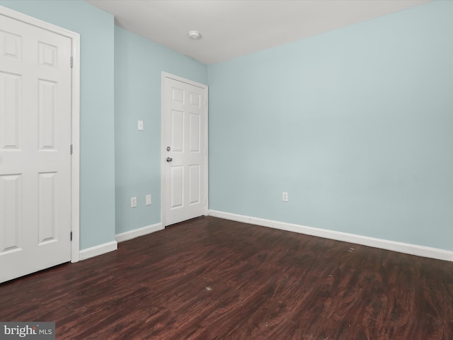 unfurnished bedroom featuring dark hardwood / wood-style floors