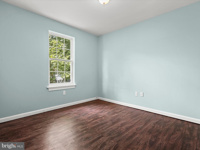 empty room featuring dark wood-type flooring