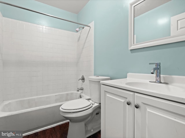 full bathroom featuring shower / bathing tub combination, hardwood / wood-style floors, vanity, and toilet