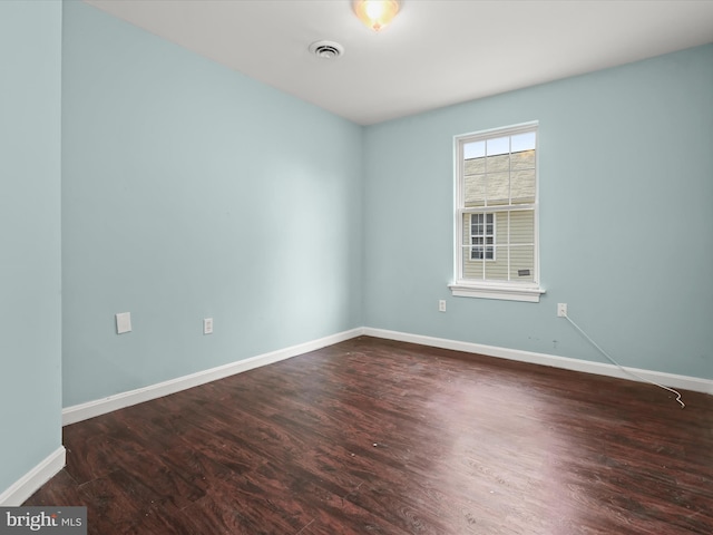 spare room with dark wood-type flooring