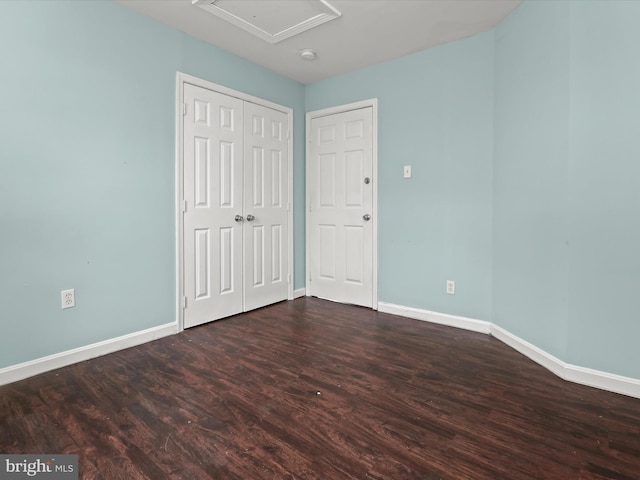 unfurnished bedroom with dark hardwood / wood-style floors