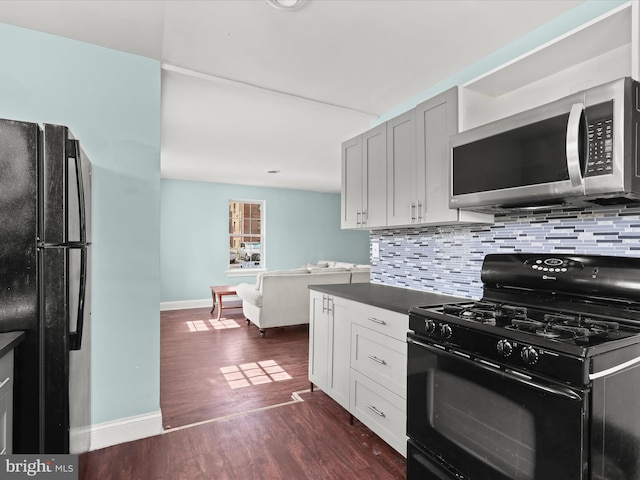 kitchen featuring decorative backsplash, black appliances, and dark hardwood / wood-style floors