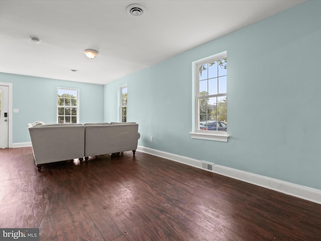 unfurnished living room with dark wood-type flooring