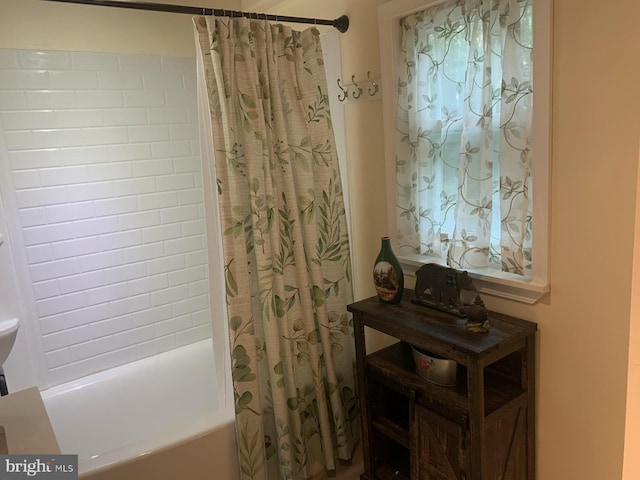 bathroom with shower / bath combination with curtain