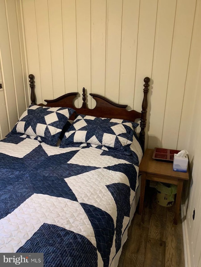 bedroom with dark wood-type flooring