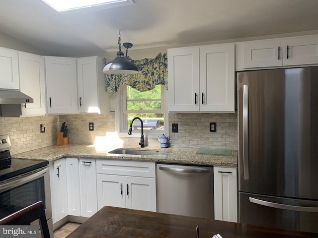 kitchen featuring white cabinetry, stainless steel appliances, sink, and pendant lighting