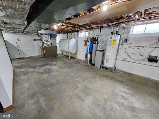 basement featuring electric water heater and heating unit