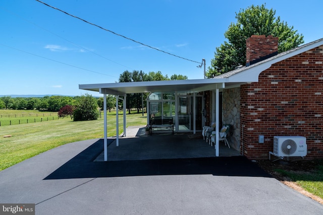 view of patio / terrace featuring ac unit and a carport