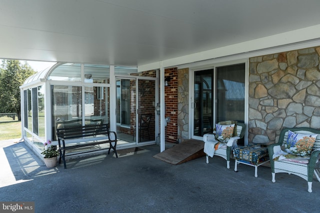 view of patio / terrace featuring a sunroom