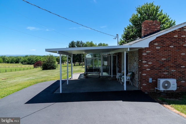 view of patio featuring ac unit and a carport