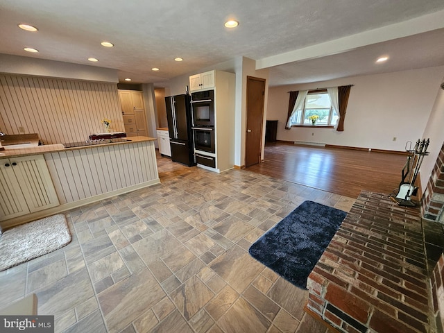 kitchen featuring white cabinets and black appliances