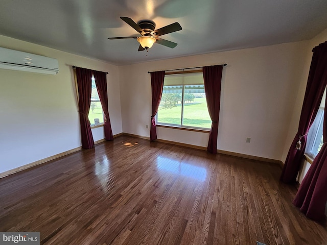 spare room featuring a wall unit AC, ceiling fan, and dark wood-type flooring