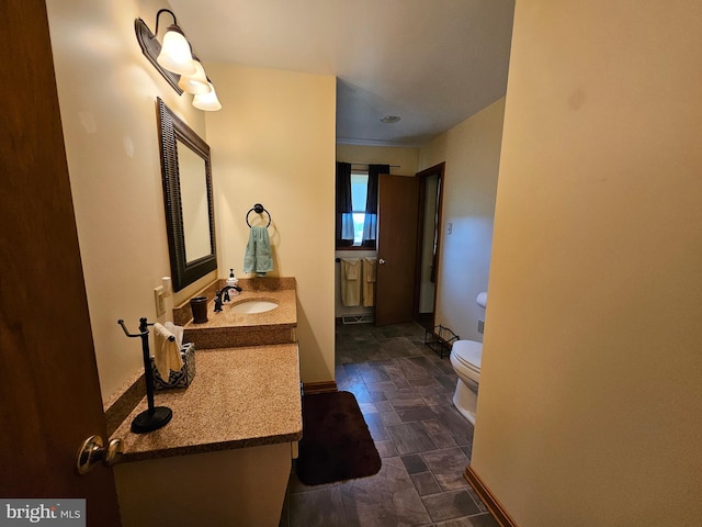 bathroom with toilet and vanity