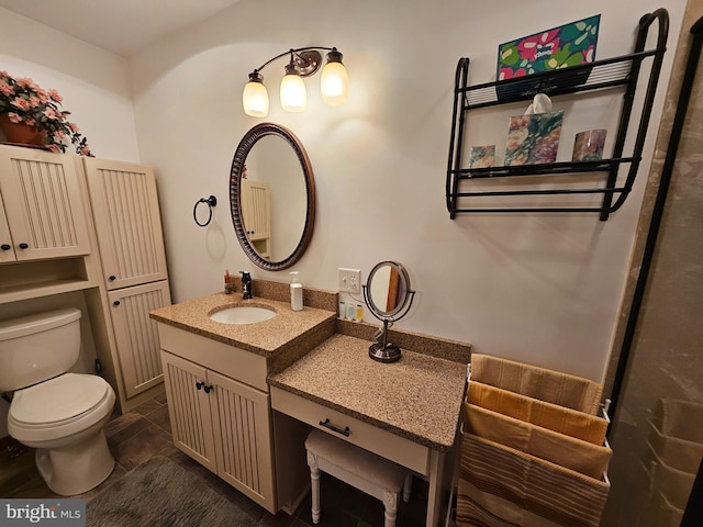 bathroom with vanity, tile patterned flooring, and toilet