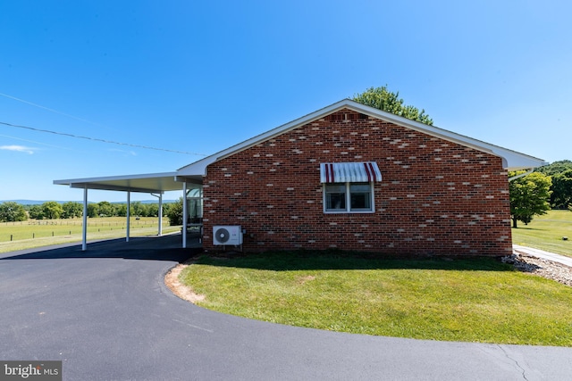 view of side of property featuring a yard and a carport