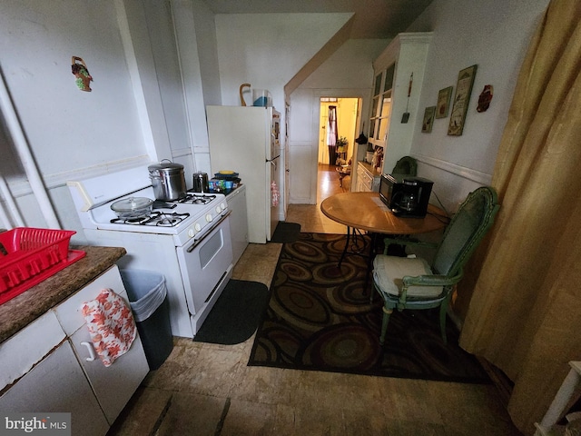 kitchen featuring white appliances and tile floors