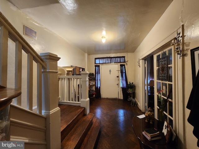 entryway featuring parquet flooring