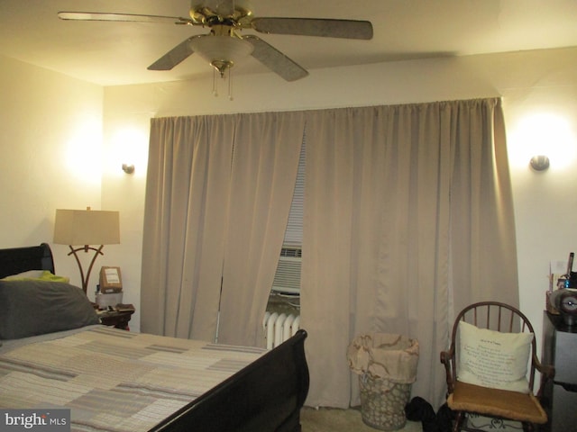 bedroom with ceiling fan, cooling unit, and radiator