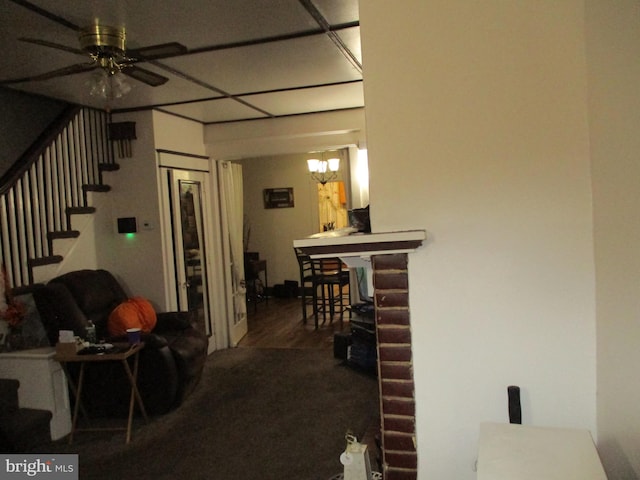 interior space featuring hardwood / wood-style flooring and ceiling fan with notable chandelier