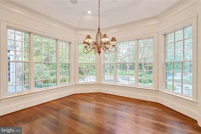 unfurnished sunroom featuring a healthy amount of sunlight and a chandelier