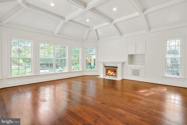 unfurnished living room with beam ceiling, wood-type flooring, and coffered ceiling