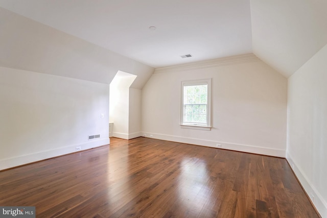 bonus room featuring dark hardwood / wood-style floors and vaulted ceiling