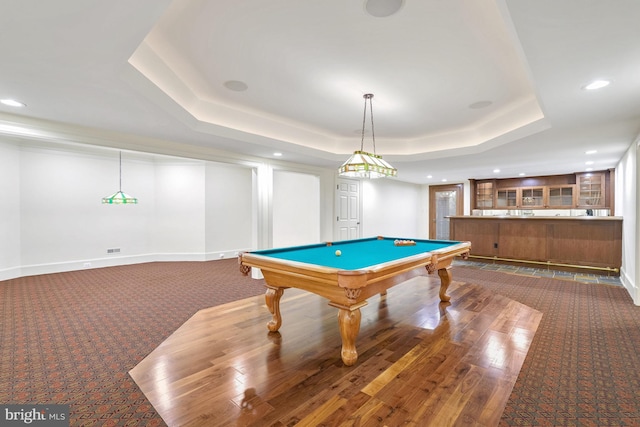 playroom featuring dark hardwood / wood-style floors, a raised ceiling, and billiards