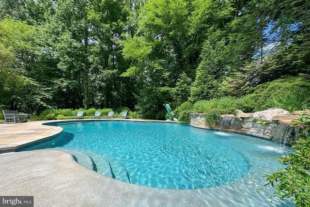 view of pool with pool water feature and a patio area