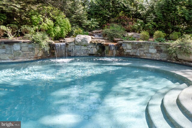 view of pool featuring pool water feature