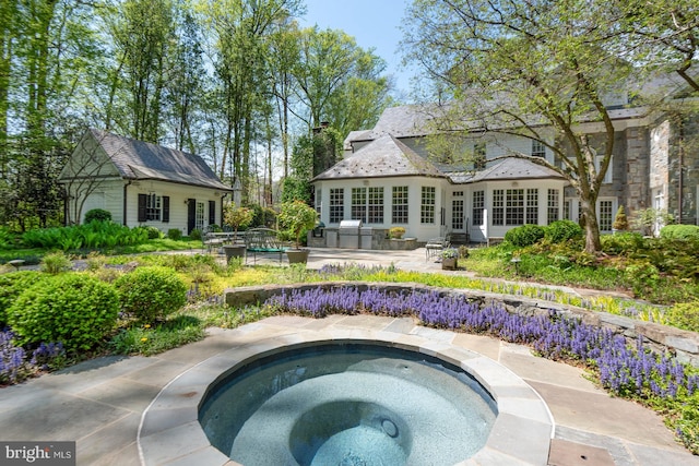 view of pool with an in ground hot tub, a patio, and french doors