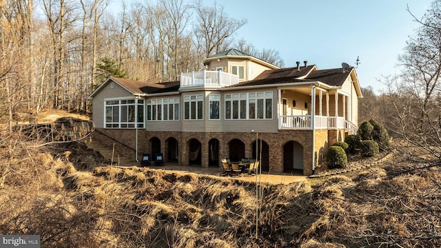 back of property with a balcony