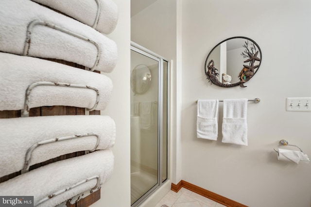 bathroom with tile flooring and an enclosed shower