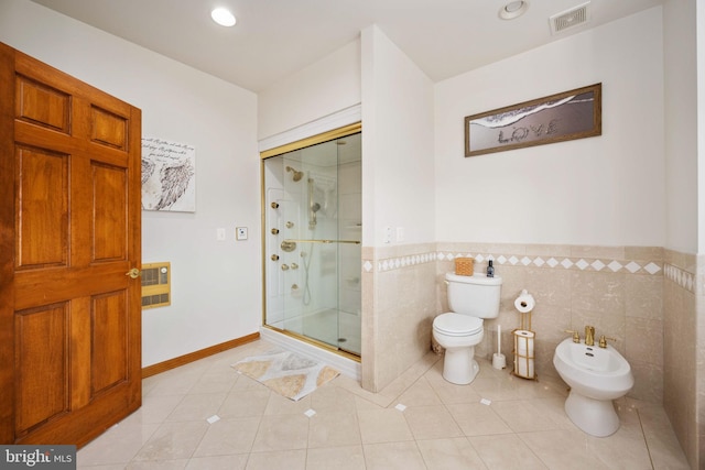 bathroom with tile flooring, a bidet, tile walls, a shower with door, and toilet