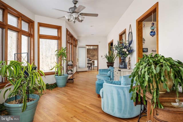 sunroom / solarium featuring ceiling fan