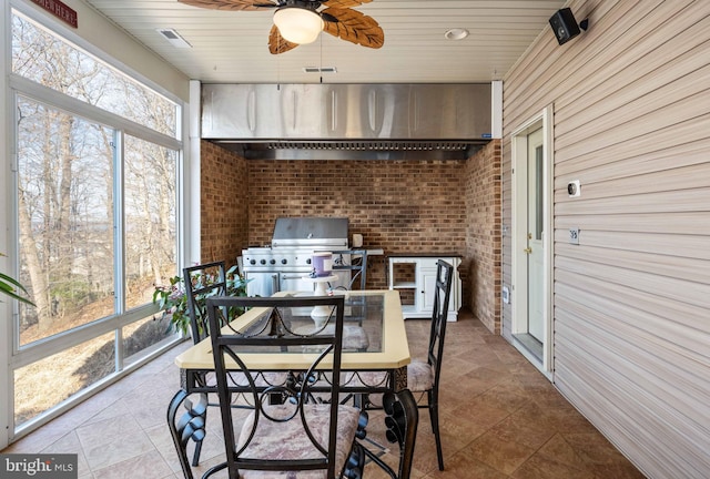 sunroom / solarium featuring ceiling fan