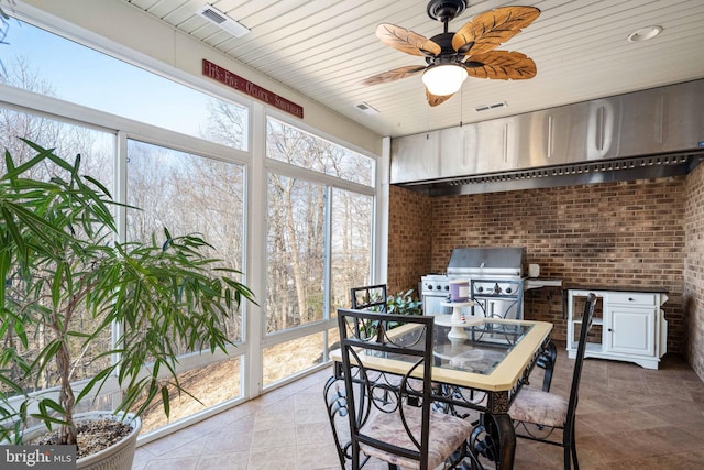 sunroom with ceiling fan and wood ceiling