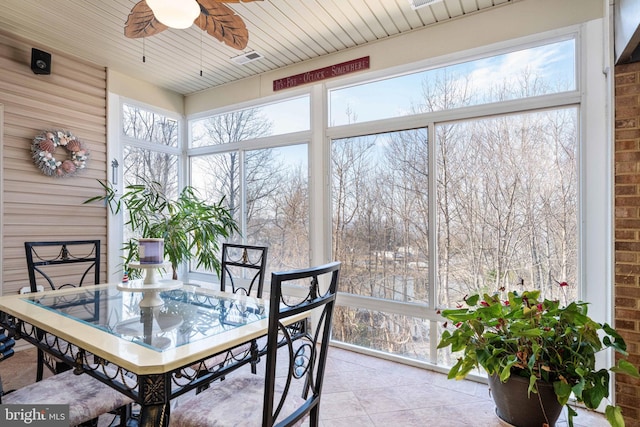 dining area featuring light tile flooring and ceiling fan