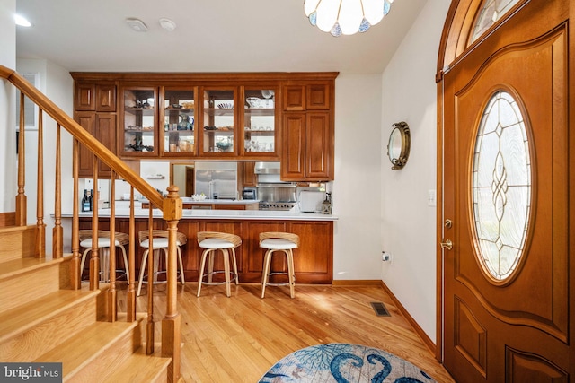 foyer featuring a wealth of natural light and light hardwood / wood-style flooring