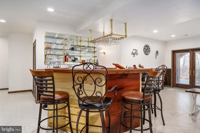 bar with french doors and light tile floors