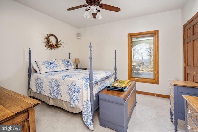 tiled bedroom featuring ceiling fan