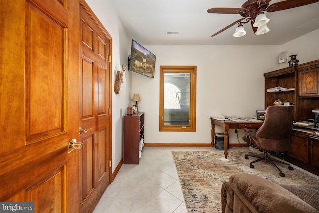 tiled home office featuring ceiling fan