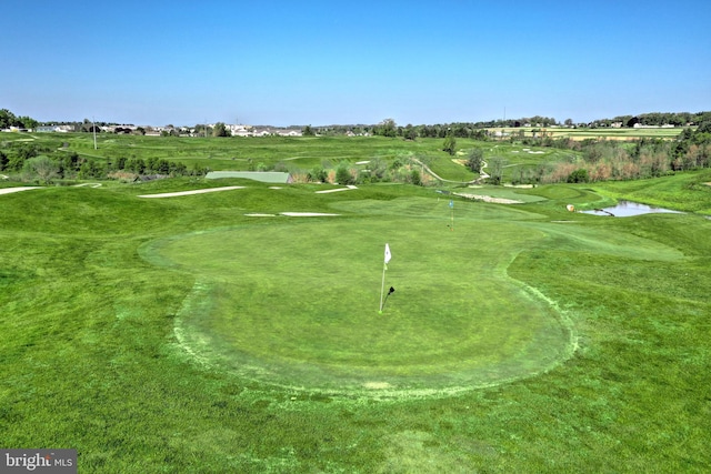 view of community featuring golf course view and a water view