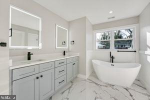 bathroom featuring vanity and a bathing tub