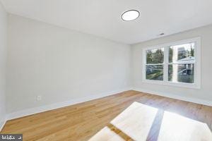 empty room with hardwood / wood-style floors