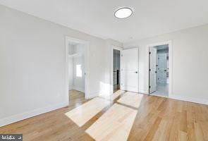 unfurnished room with hardwood / wood-style flooring