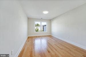 spare room featuring light hardwood / wood-style floors