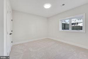 unfurnished room with light colored carpet