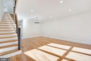 interior space with a chandelier and wood-type flooring