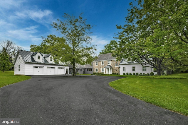 view of front of property with a front yard and a garage