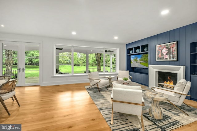 living room with french doors and light wood-type flooring